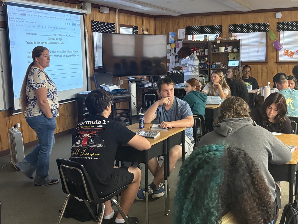 Teacher standing at the board.