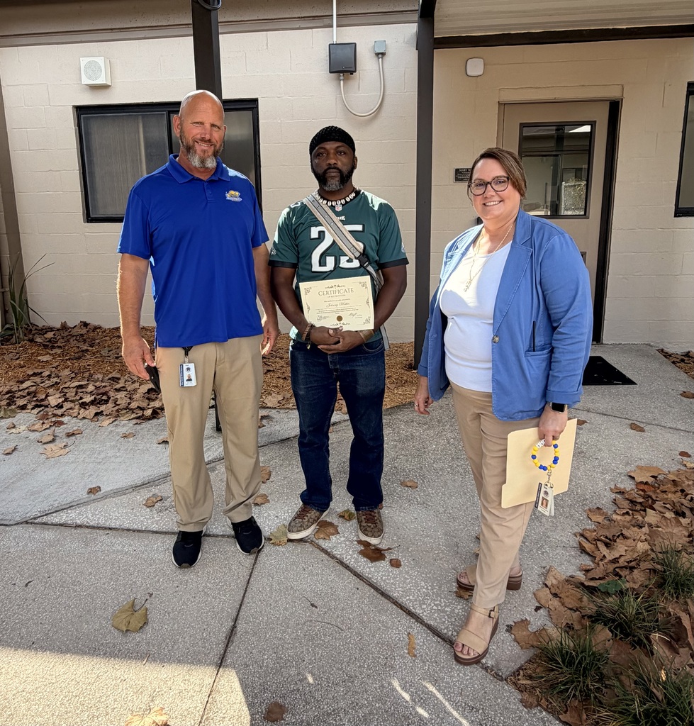 Mr. Cox, Mr. Mathis, and Mrs. Palmer holding certificate for SOY