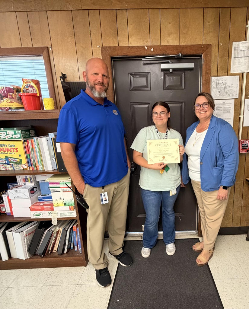 Mr. Cox, Ms. Layfield, and Ms. Palmer holding a certificate for SOY 