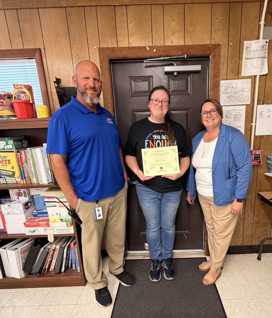 Mr. Cox, Ms. Stettner, and Ms. Palmer holding a certificate for TOY.