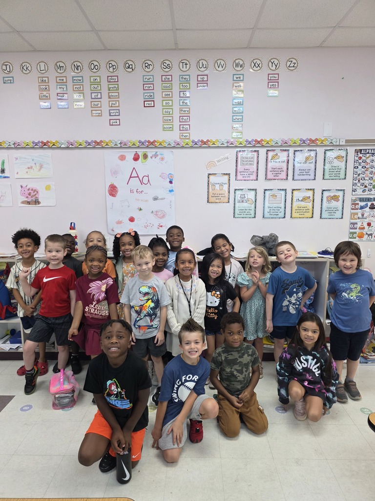 A classroom with students posing for a group photo.