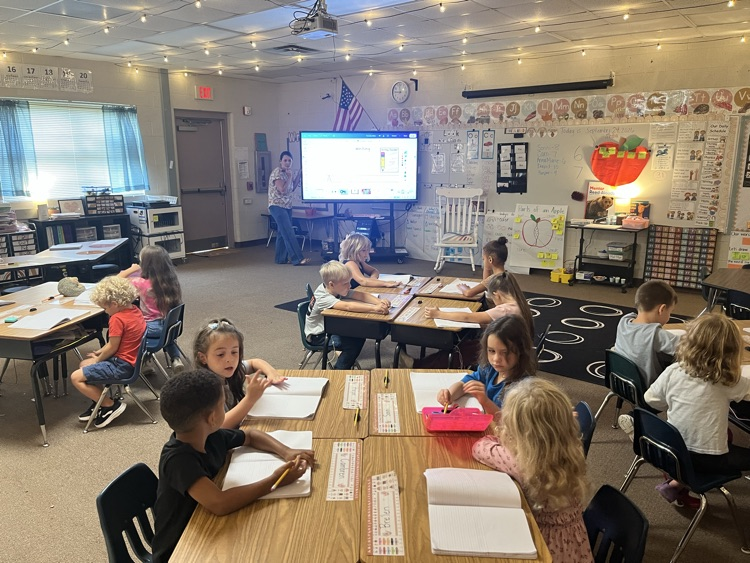 kindergarten class working on writing 