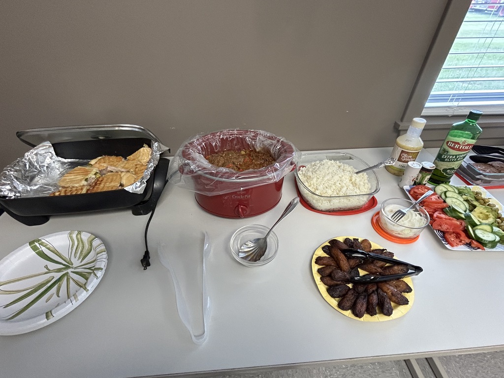 CVA staff members serve themselves from a buffet of homemade Cuban dishes prepared for the Teacher and School-Related Employee of the Year celebration.