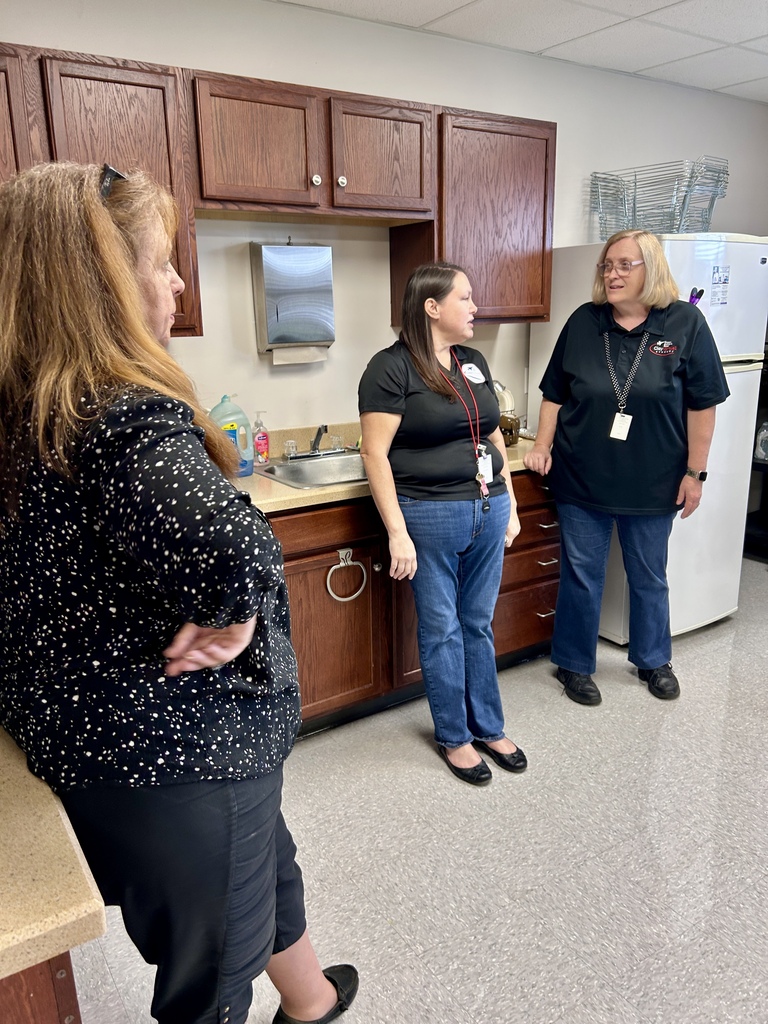 CVA Assistant Principal Linda Garcia visits with colleagues near the kitchen after preparing the Cuban lunch for Friday’s celebration.