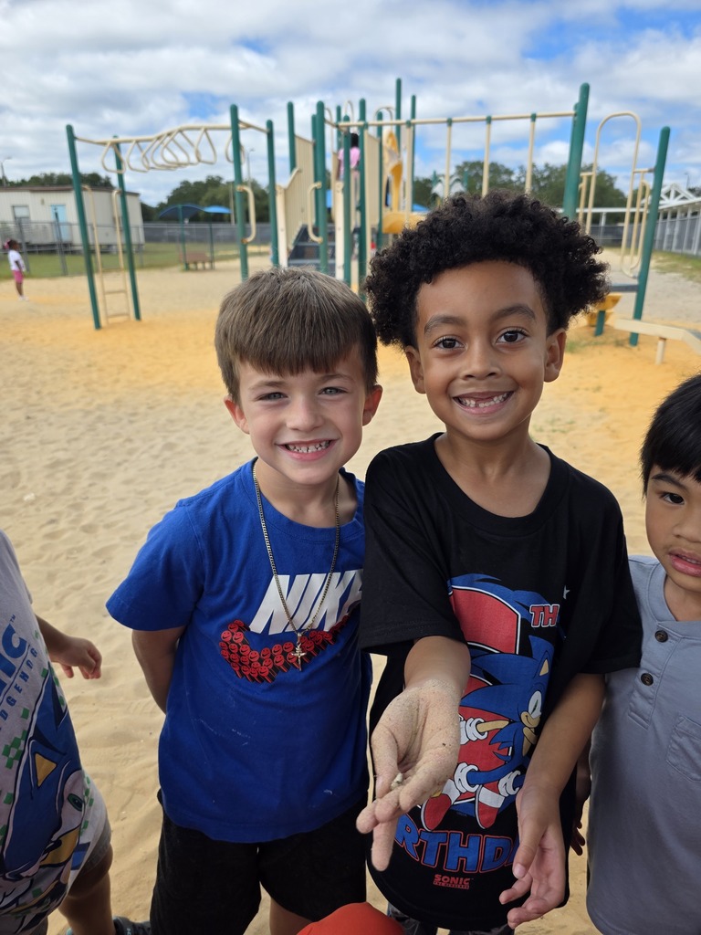 Students posing for a picture wearing red, white, and blue