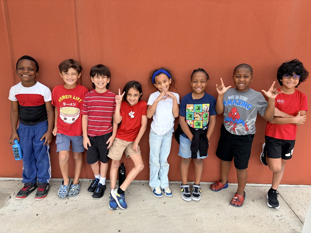 Students posing for a picture wearing red, white, and blue