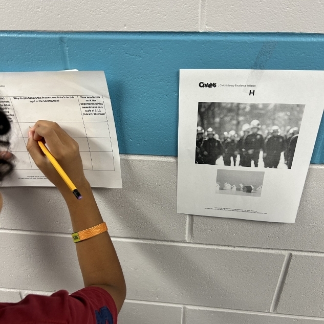 Students working writing to support their thinking. 