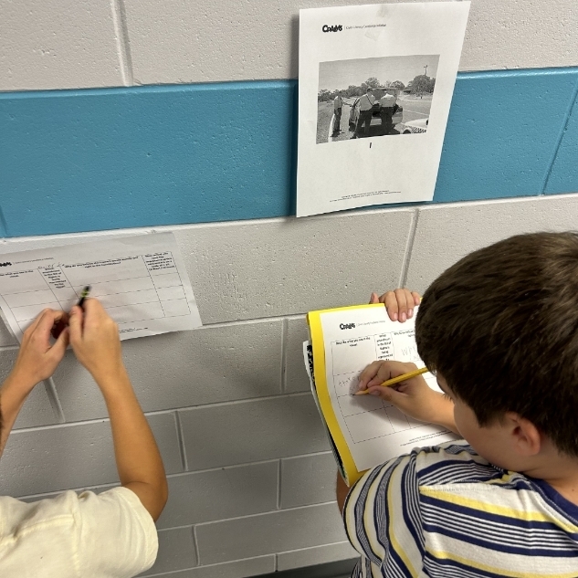 Students working writing to support their thinking. 