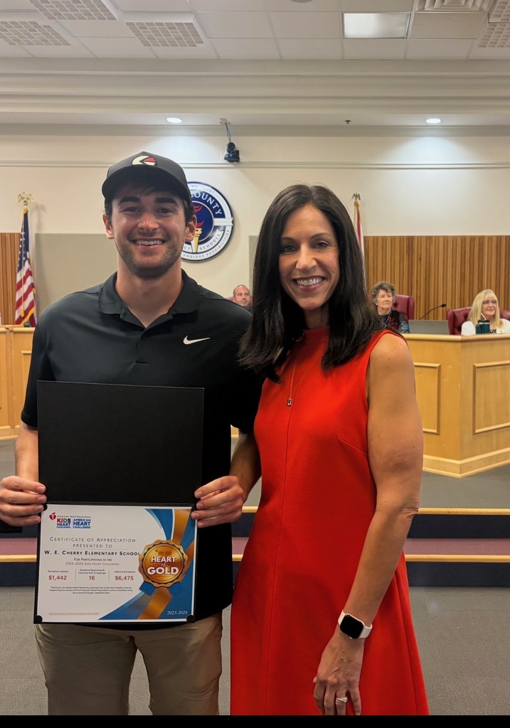 Coach Brooks and Mrs. Gottberg at the school board meeting.