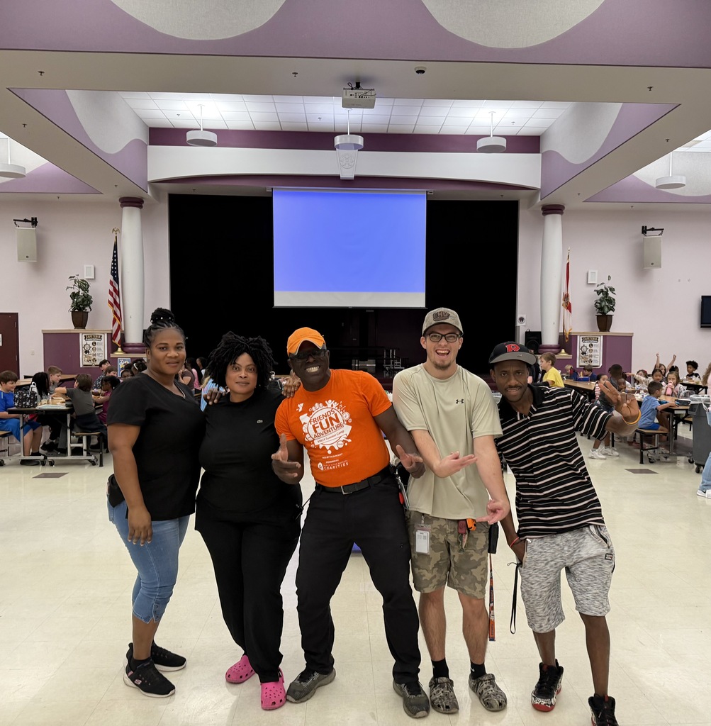 OVE custodians posing for a picture in the cafeteria