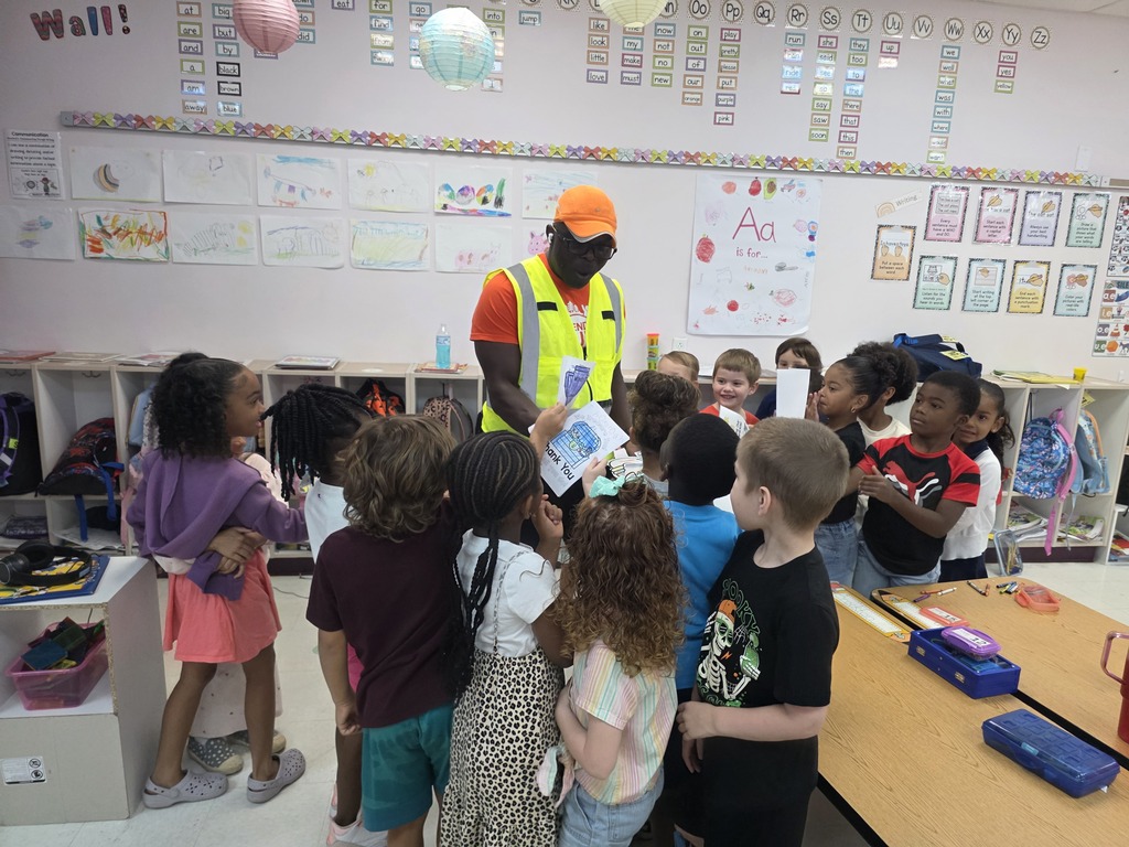 Kindergarten students giving thank you cards to the head custodian