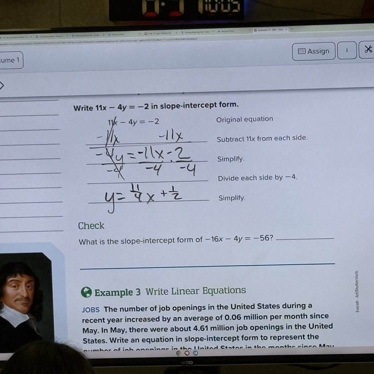 teacher working through problems on the board