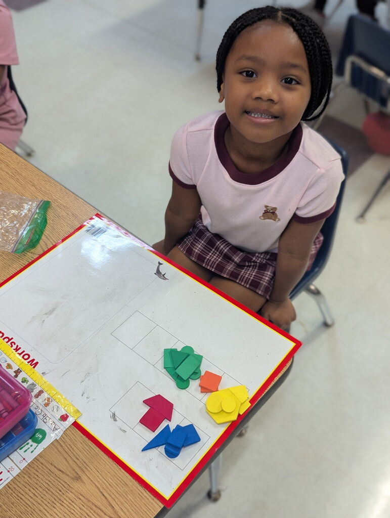 Photo of student sorting shapes on a work mat