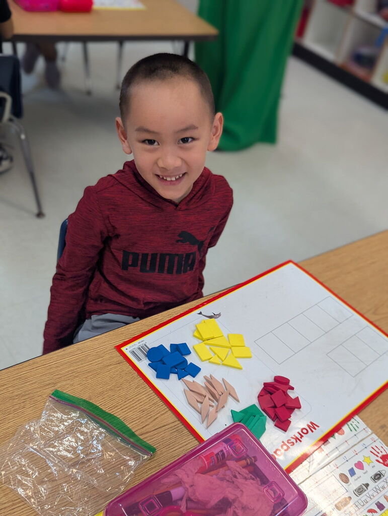 Photo of student sorting shapes on a work mat