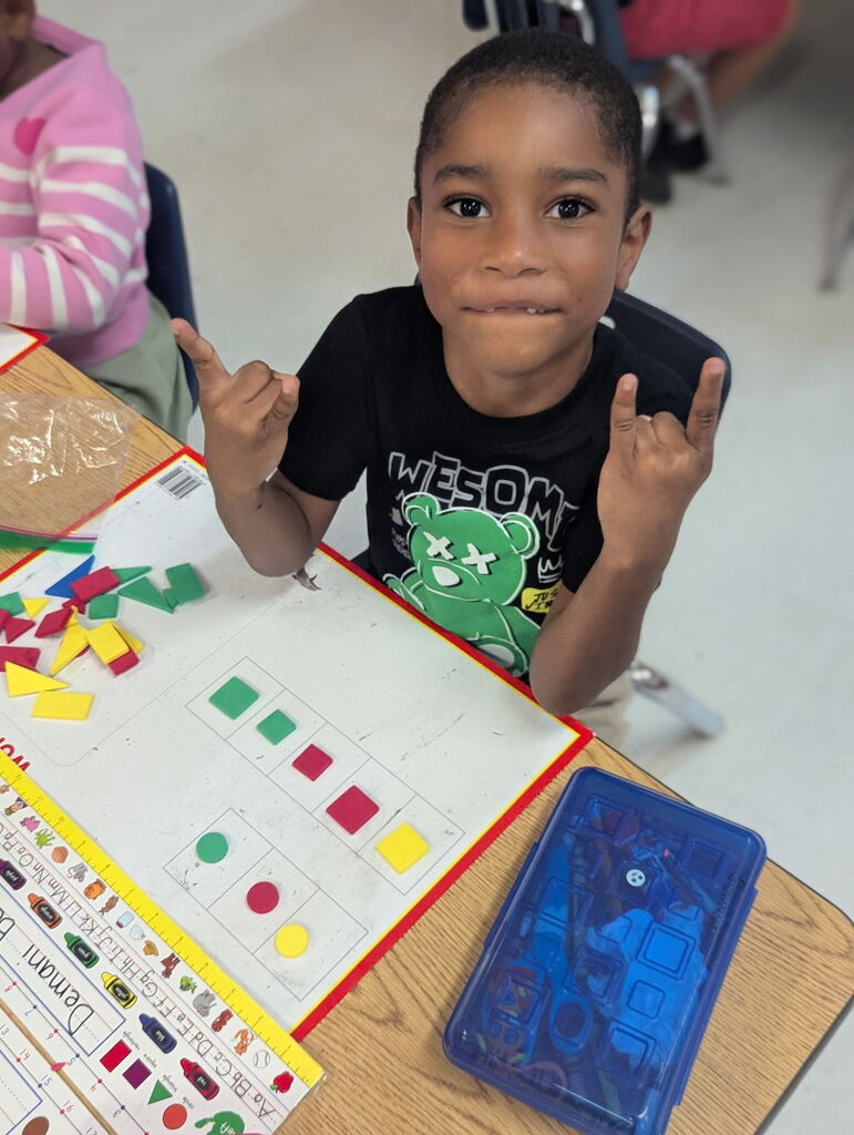 Photo of student sorting shapes on a work mat