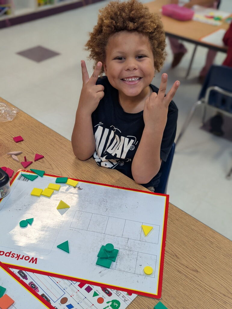 Photo of student sorting shapes on a work mat
