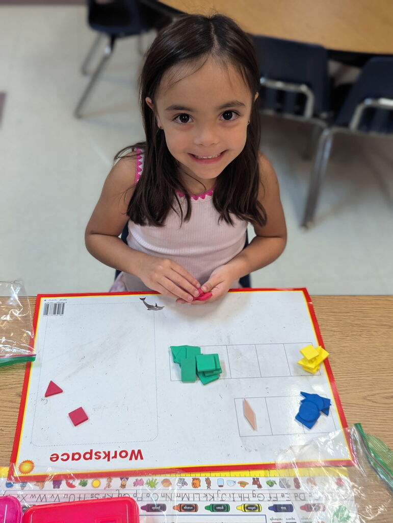Photo of student sorting shapes on a work mat