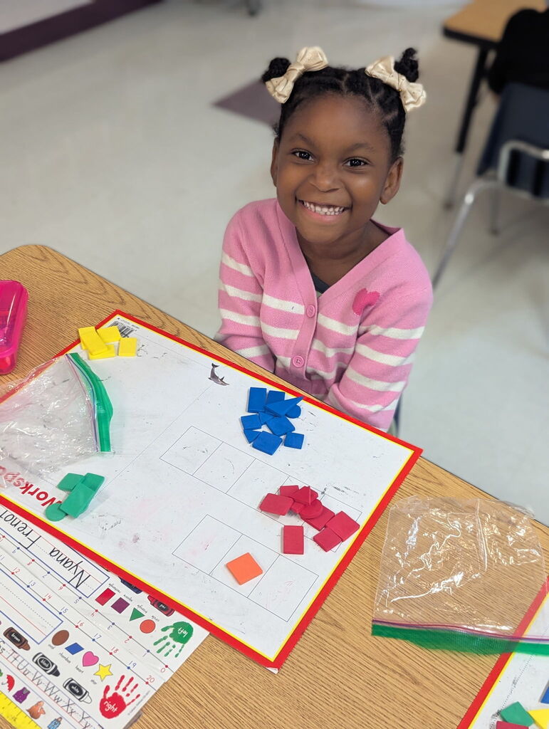 Photo of student sorting shapes on a work mat