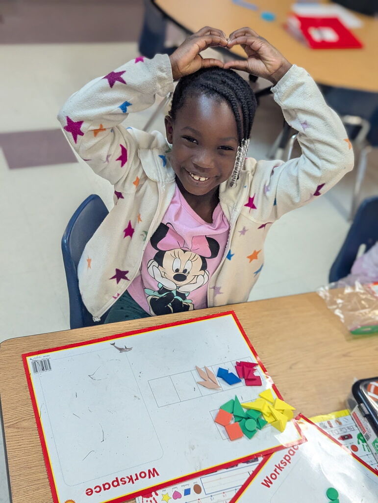 Photo of student sorting shapes on a work mat