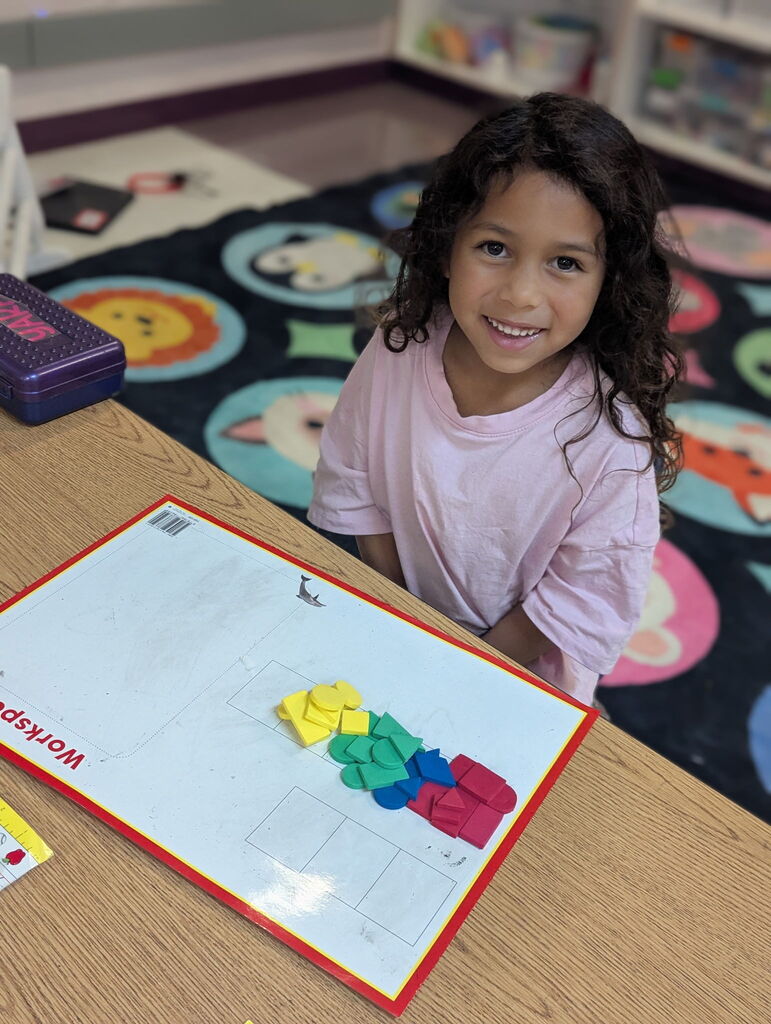 Photo of student sorting shapes on a work mat