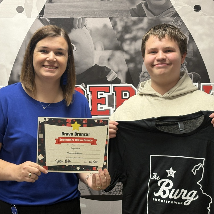 assistant principal with student receiving an award