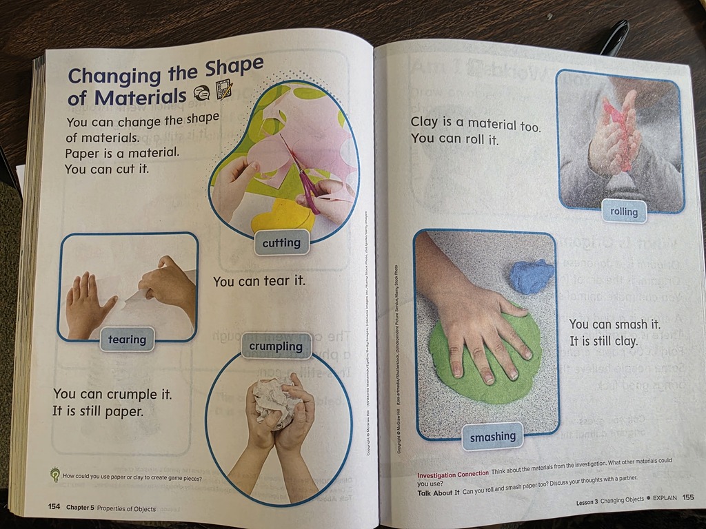 An open book titled "Changing the Shape of Materials" displays hands engaged in various activities like cutting, scrunching, and smearing.