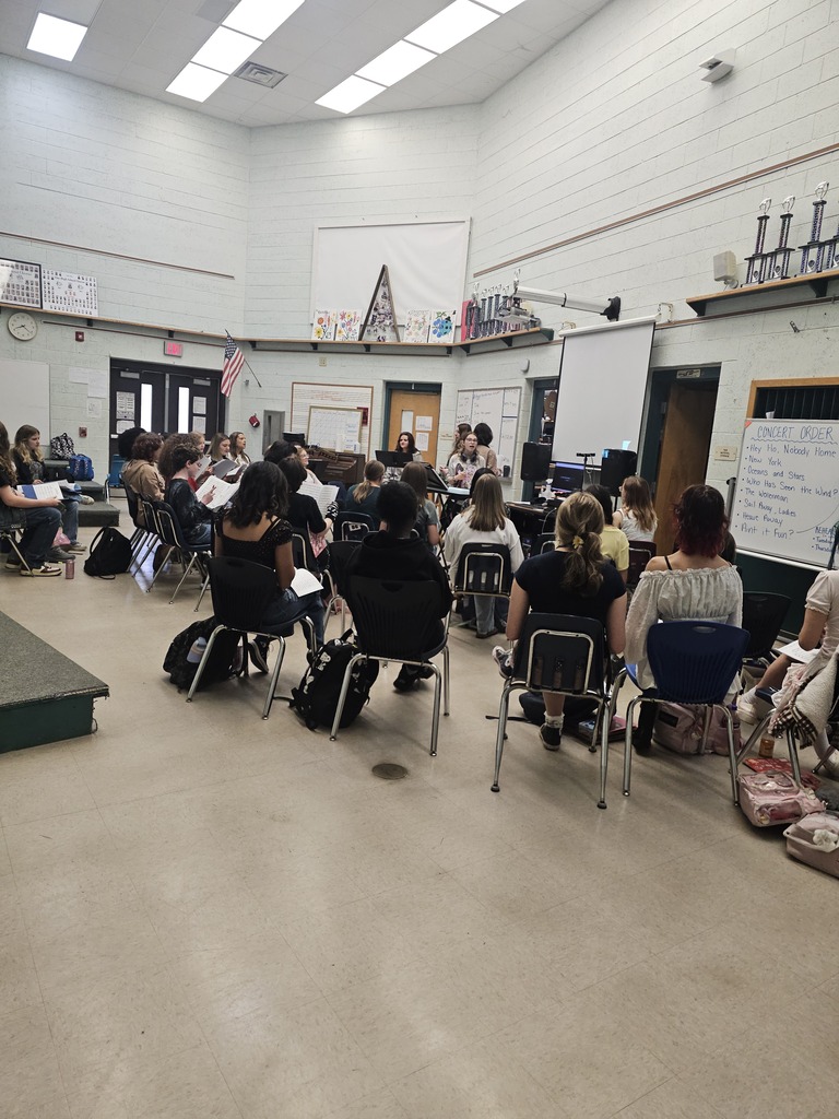 An overhead view of a classroom with students seated in chairs, working at their desks.