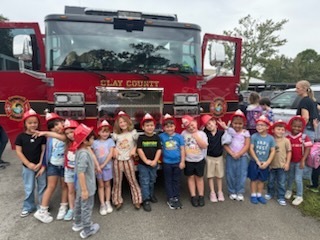 Students stand in front of a fire truck