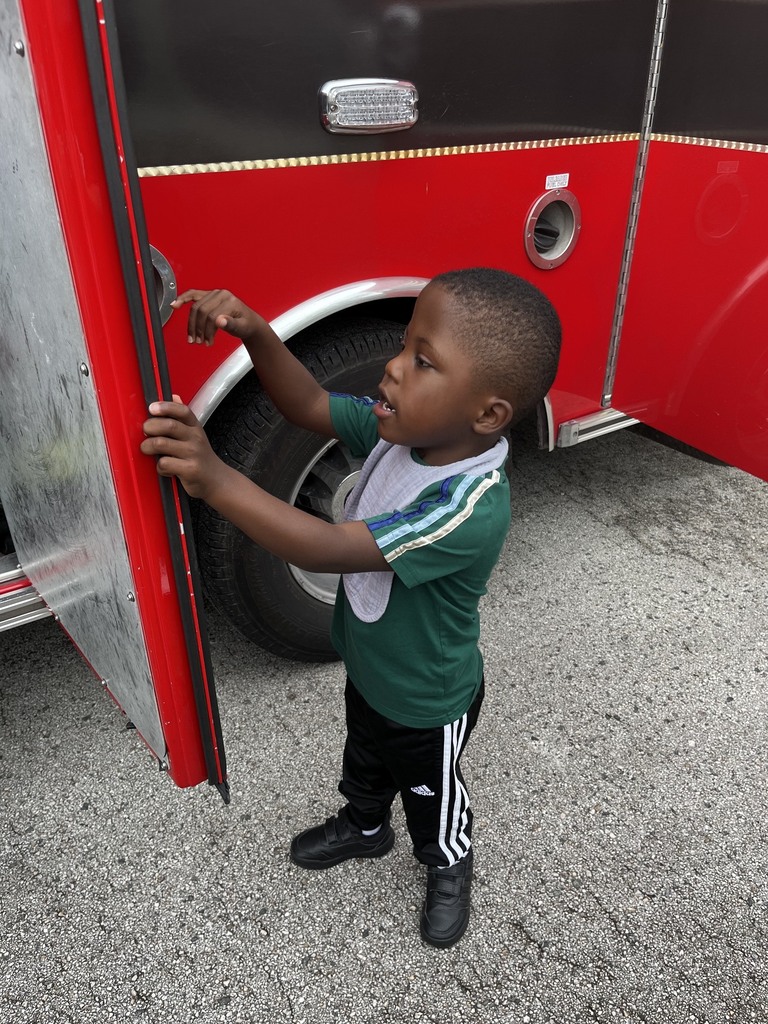 Boy checking out a fire truck