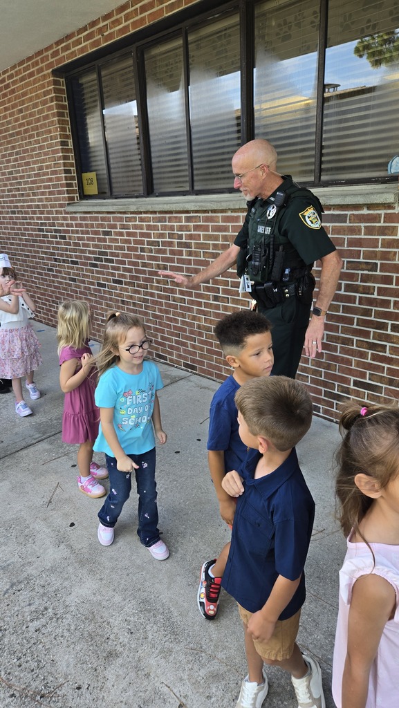 Officer high fives students