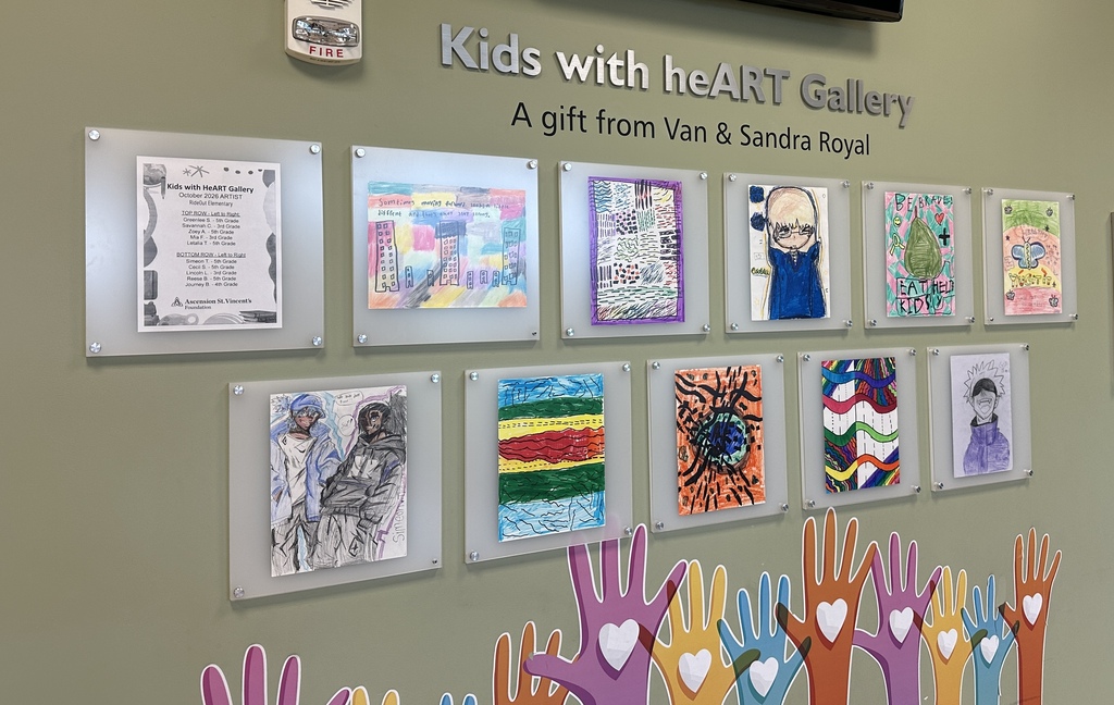 A wall displays children's artwork with the text "Kids with heART Gallery" and a note from Van and Sandra Royal.