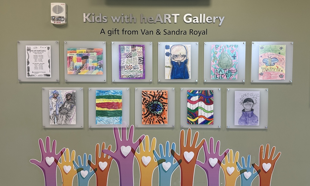 Multiple colorful children's art pieces, with hands and hearts, displayed on a wall with the text "Kids with theART Gallery."