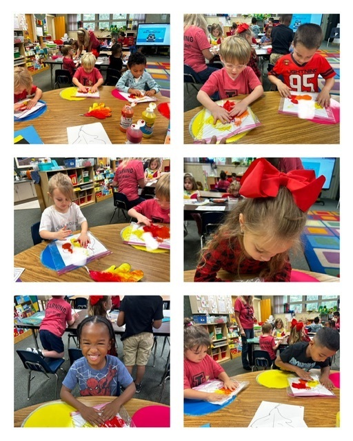 A classroom with children at tables working on paper crafts. Some have bowls of colored papers.