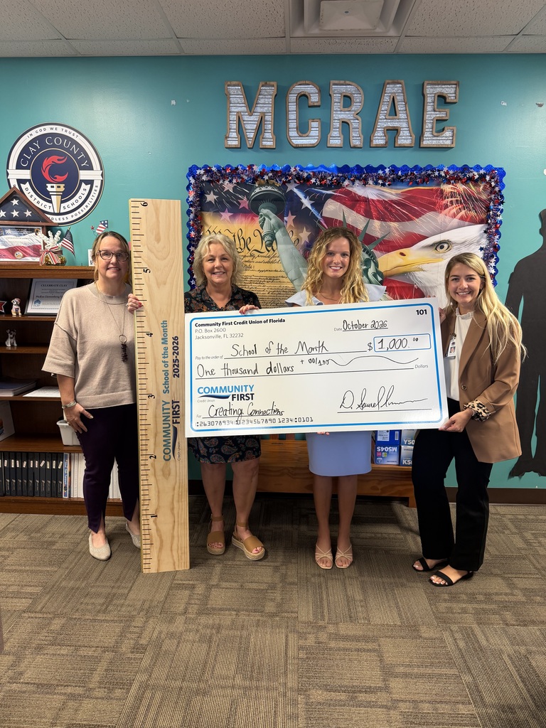 A group of individuals from Fleming Island High who are holding a check and a large sized ruler from community first credit union
