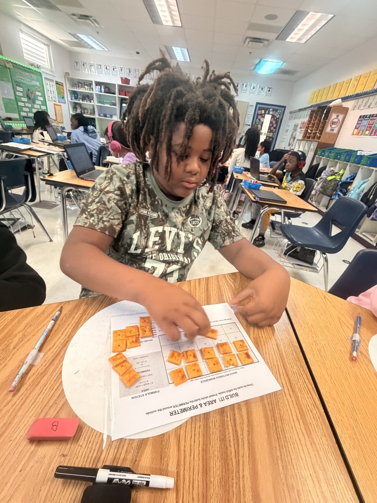 Student working on a math assignment with snacks.