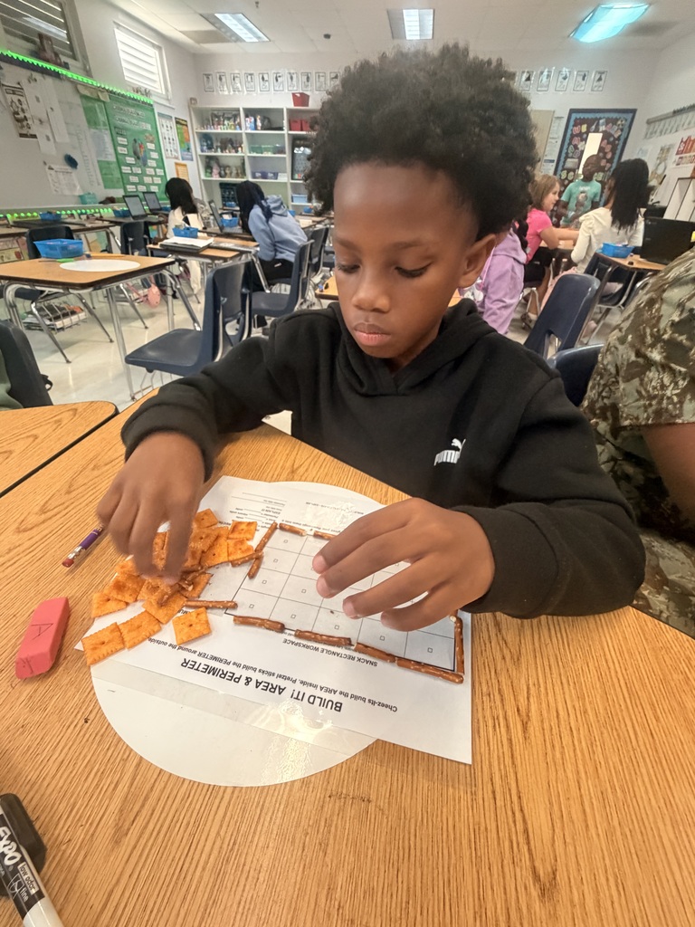 Student working on a math assignment with snacks.