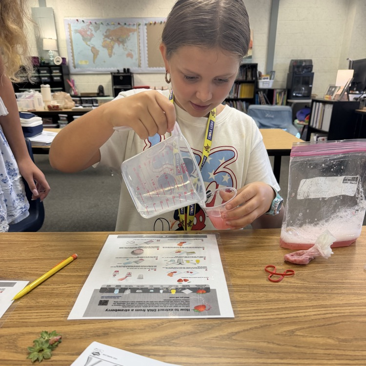 student measuring liquid