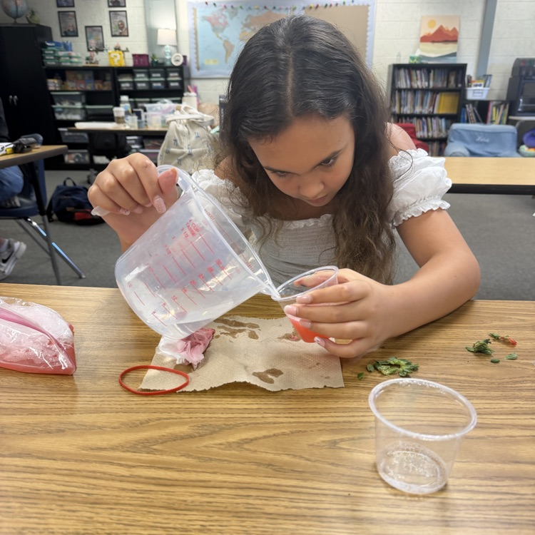 student measuring liquid