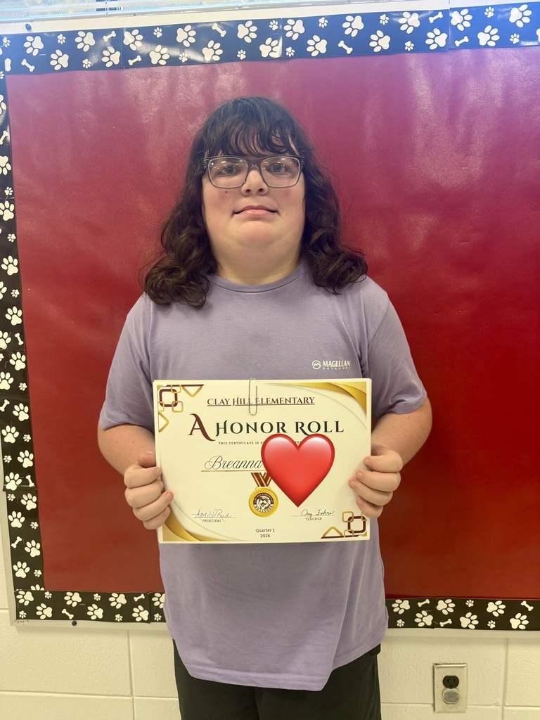A person holds a certificate with a red heart and text reading "A Honor Roll" against a red background.