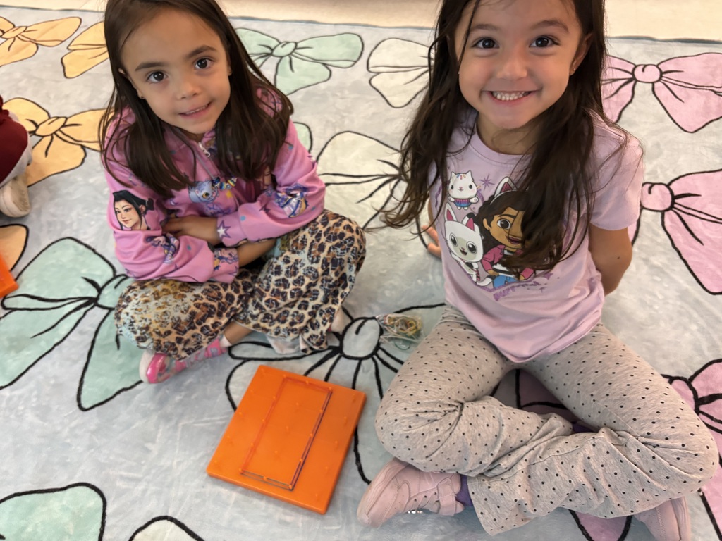 Students use rubber bands to build shapes on geoboards.