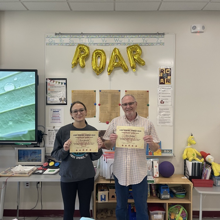 Picture of one of our teachers and his classroom assistant who take care of our students