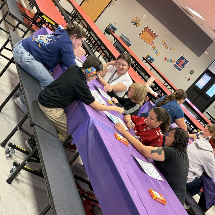 Students enjoying playing math games with their family during the title 1 math night