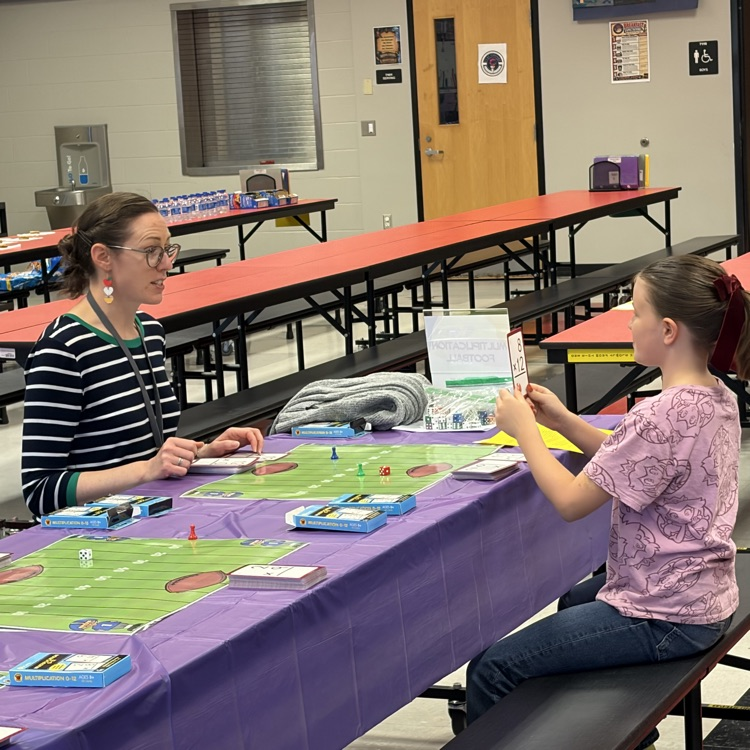 Students enjoying playing math games with their family during the title 1 math night