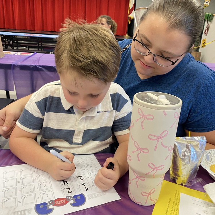 Students enjoying playing math games with their family during the title 1 math night
