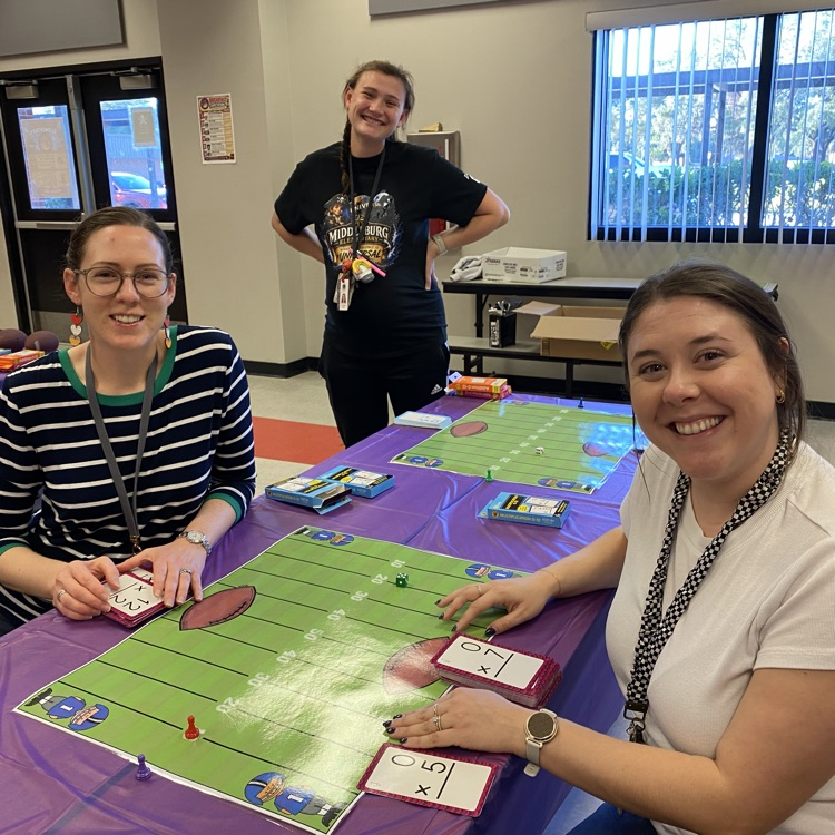 Students enjoying playing math games with their family during the title 1 math night