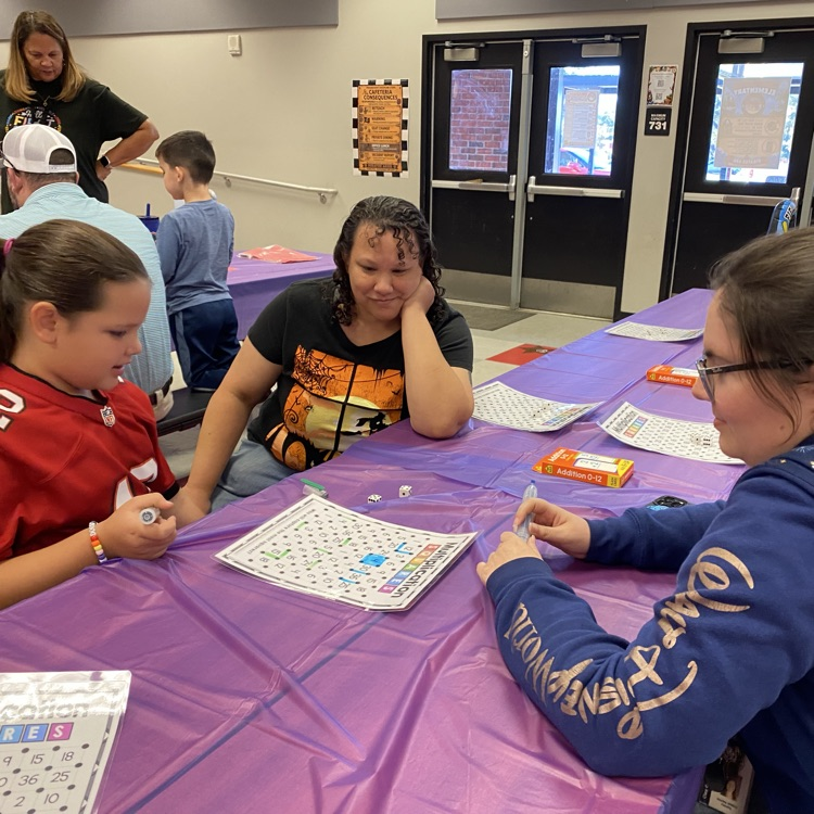 Students enjoying playing math games with their family during the title 1 math night