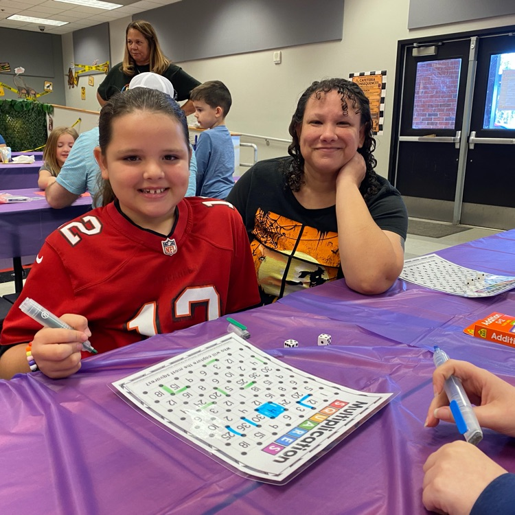 Students enjoying playing math games with their family during the title 1 math night