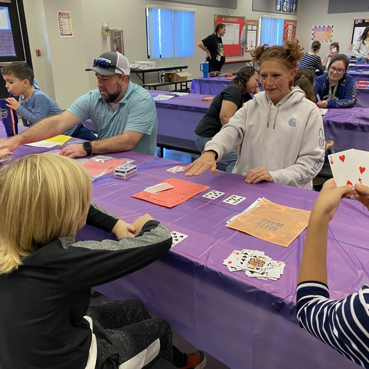 Students enjoying playing math games with their family during the title 1 math night