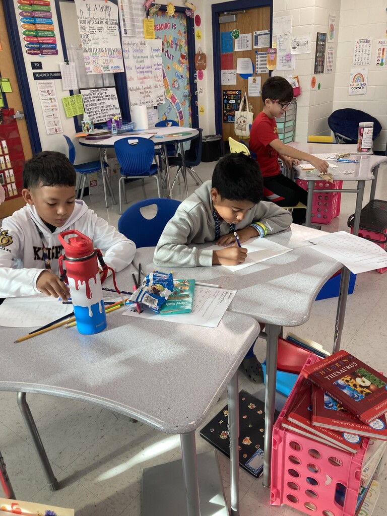 Students seated at desks writing