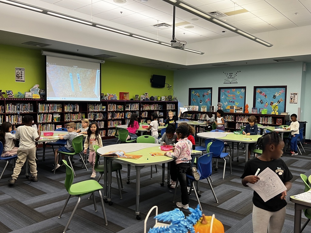 young students making reading pointers in media class